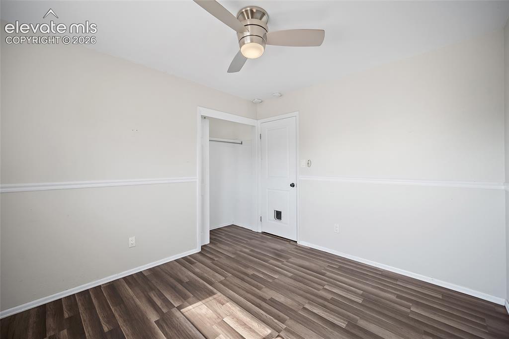 Image 19 of 50: Bedroom with ceiling fan and updated flooring.
