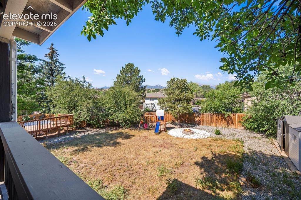 Image 30 of 50: Fenced backyard with mature trees.