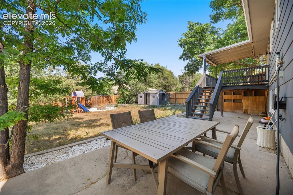 Image 34 of 50: Patio with vews of the spacious backyard.