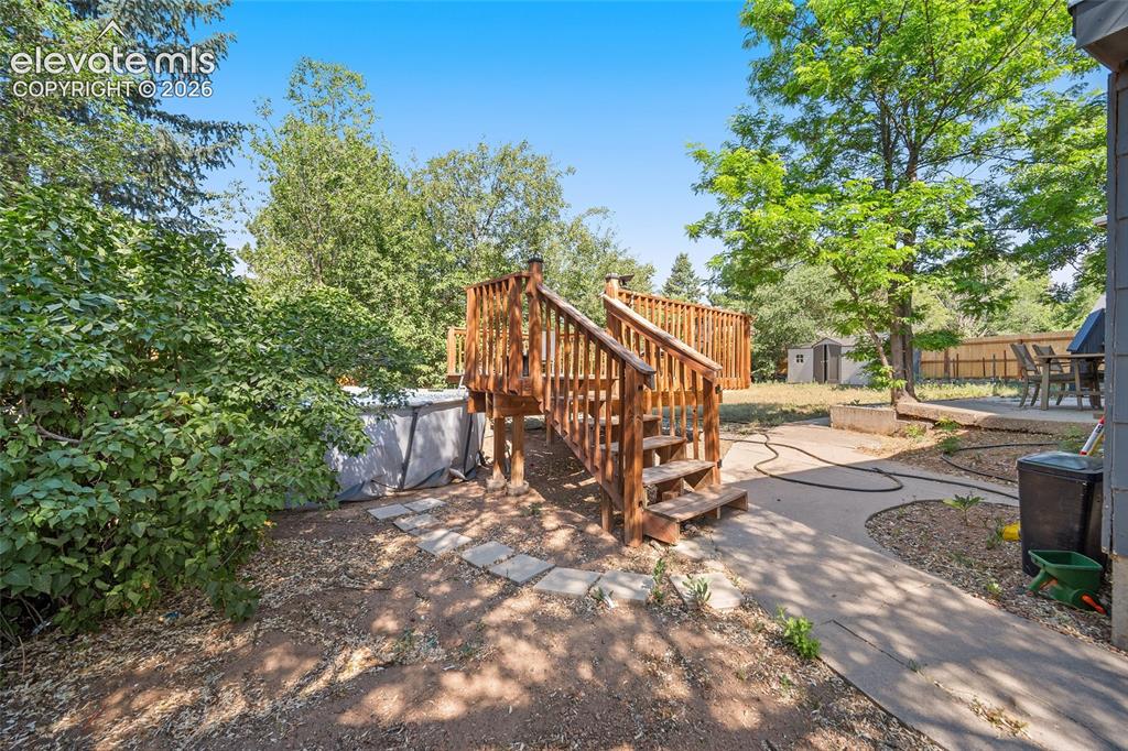 Image 35 of 50: Backyard with deck access.