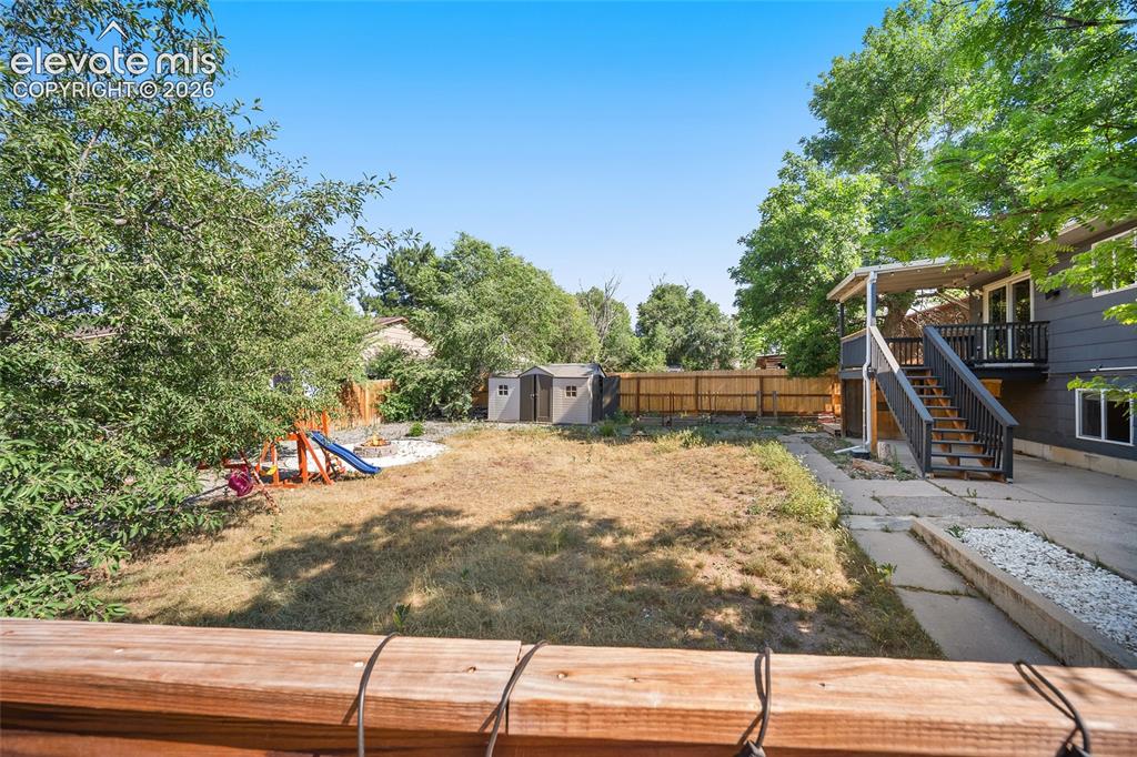 Image 36 of 50: Backyard with view of deck.