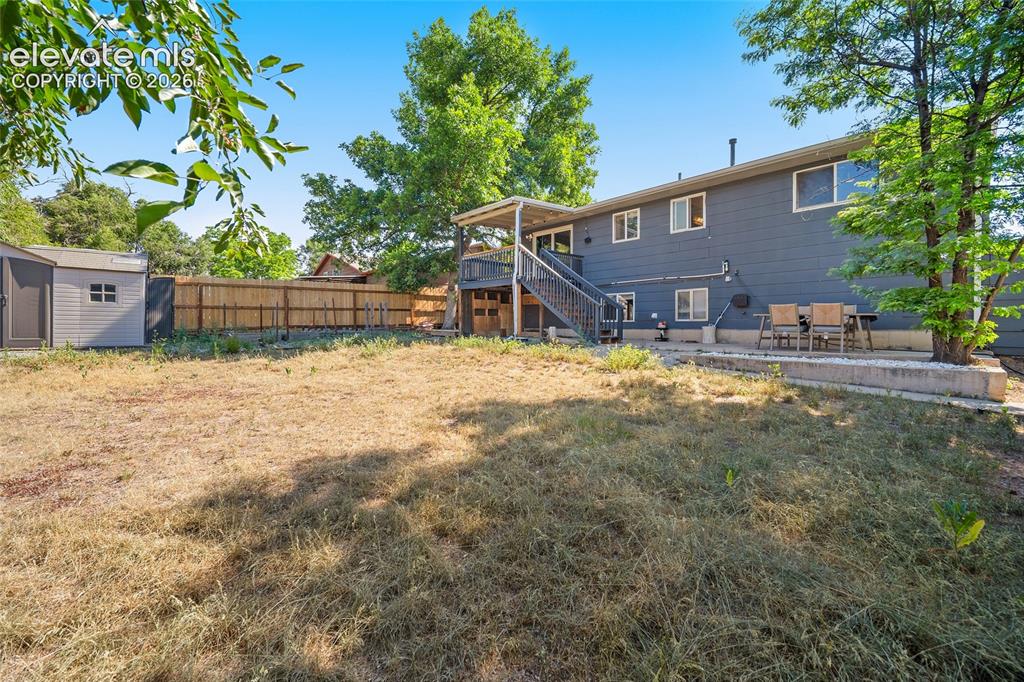 Image 37 of 50: Spacious backyard viewing property.