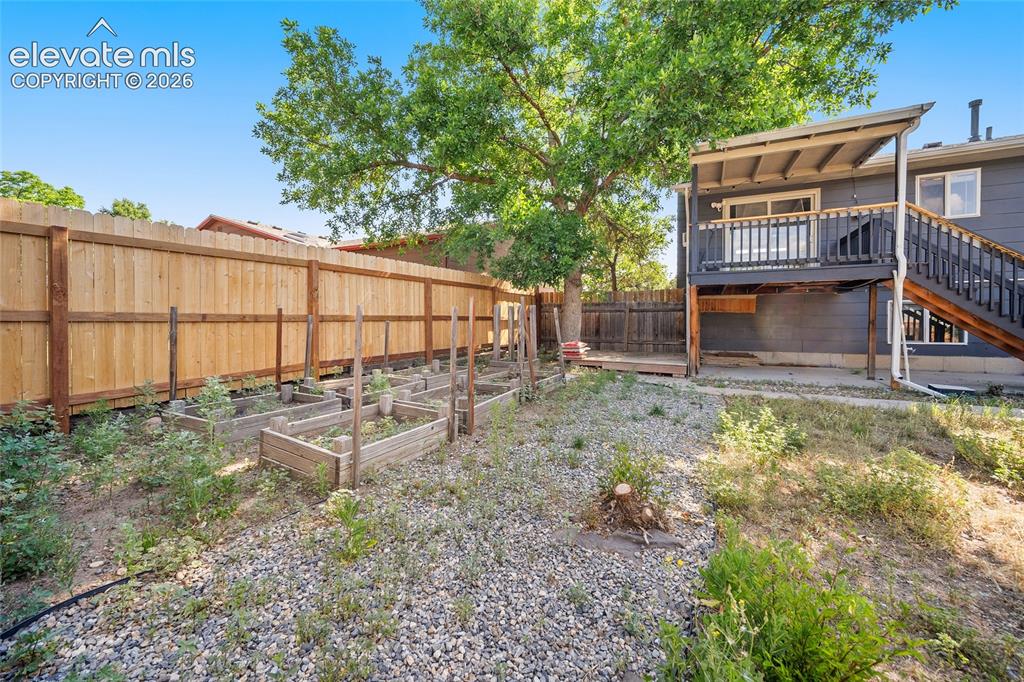 Image 39 of 50: A serene area to garden and view of the back of the home.