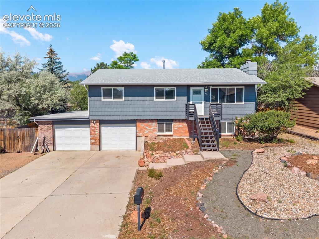 Image 41 of 50: Front exterior featuring a two car garage and inviting entry.