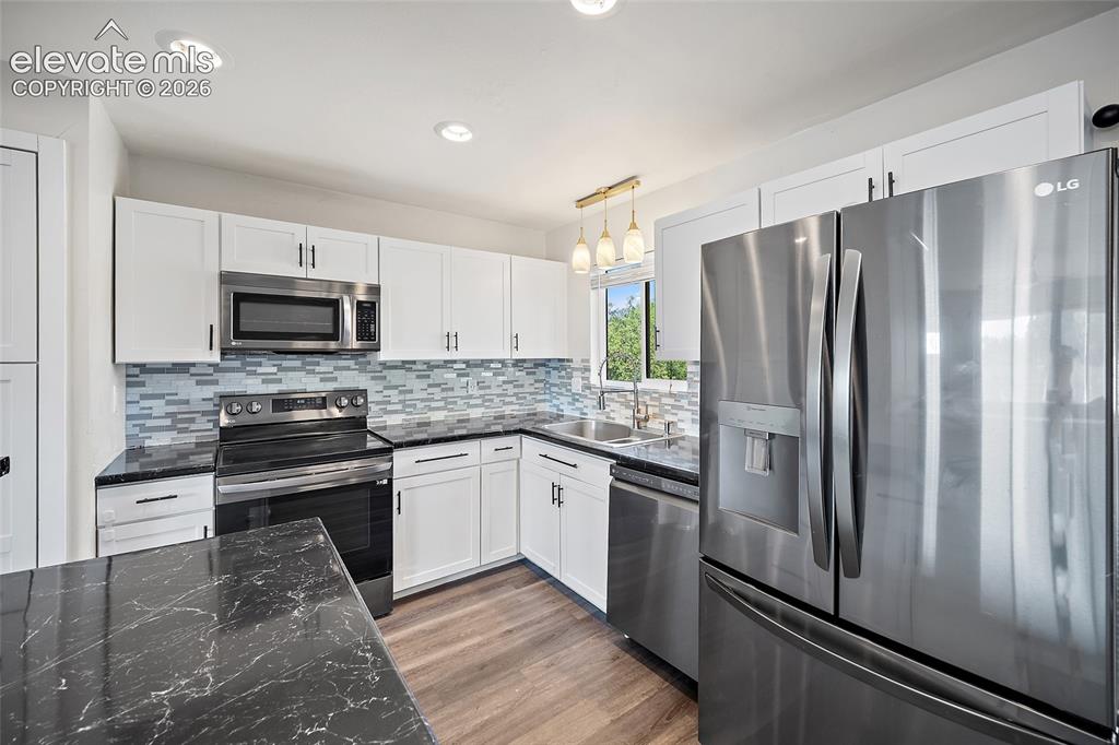 Image 9 of 50: Updated kitchen with stainless steel appliances.