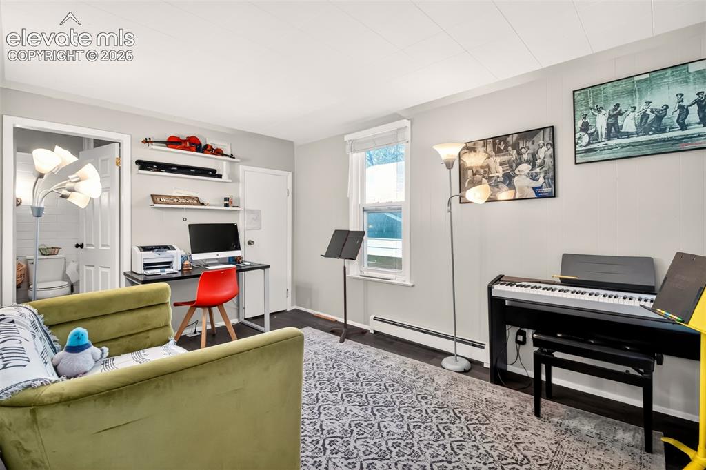 Image 11 of 30: Main level bedroom with closet and attached bath.