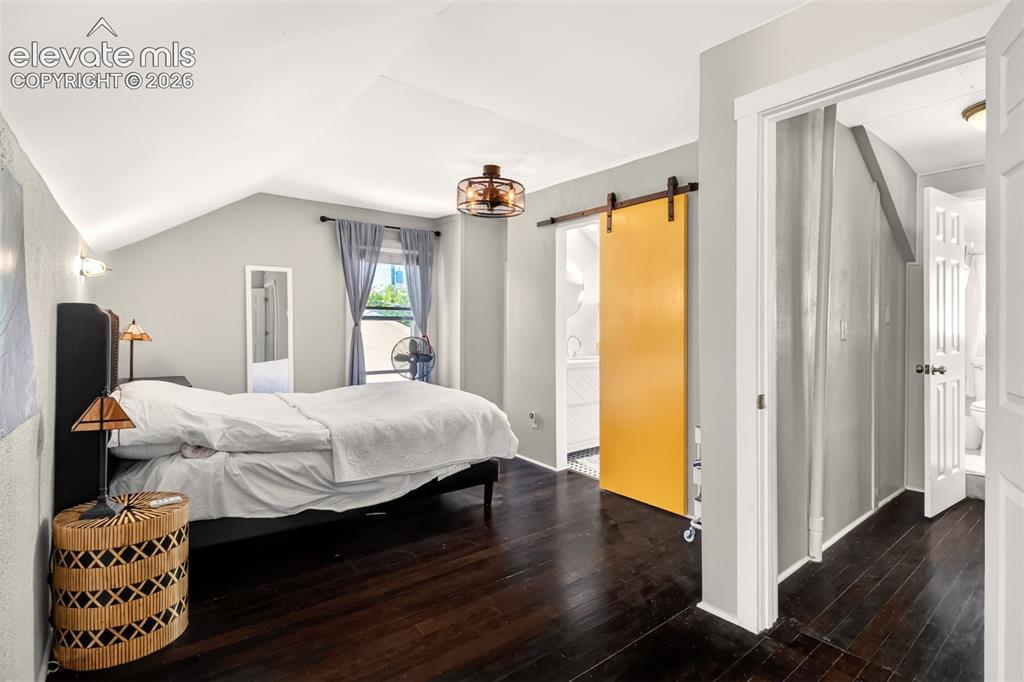 Image 15 of 30: Upper level bedroom with attached bathroom