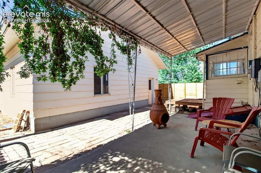 Image 24 of 30: Covered back patio and garage