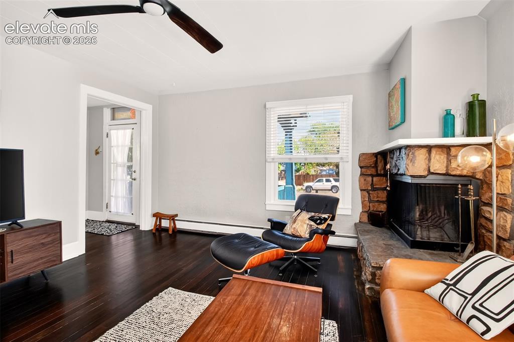 Image 4 of 30: Inviting living room, rich hardwood flooring
