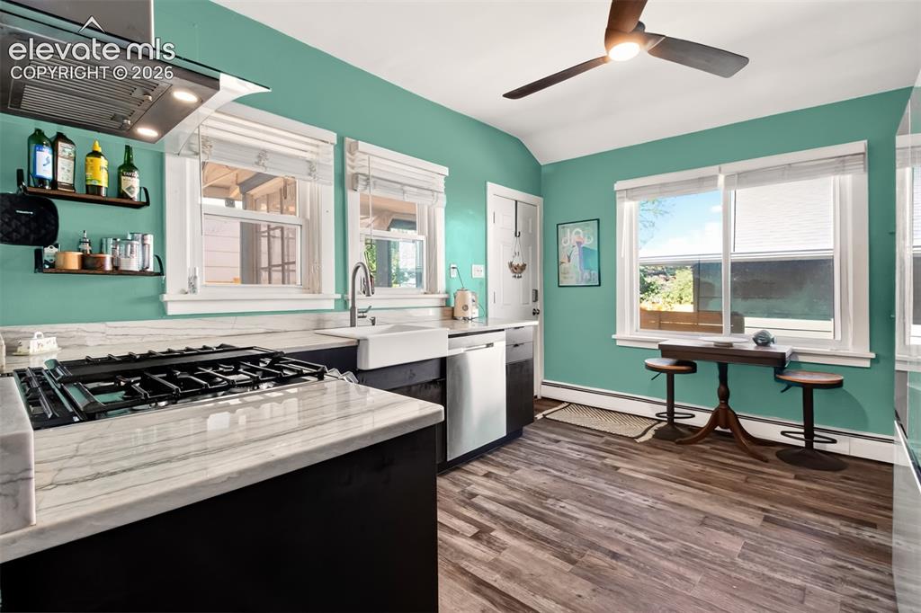 Image 9 of 30: Gorgeous luxury vinyl flooring, farm sink, gas stove