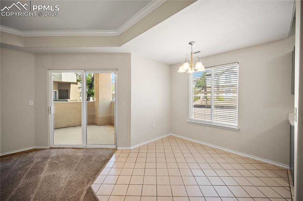 Image 11 of 31: Interior space featuring a recessed ceiling, crown molding, and a built-in 