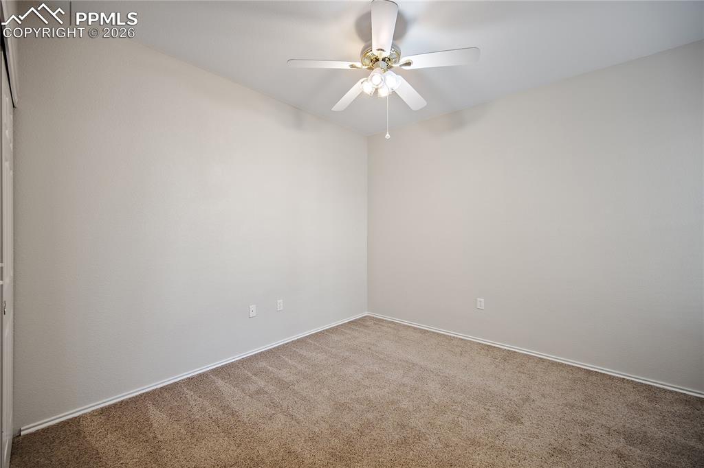 Image 26 of 31: Room featuring textured walls, neutral carpet, a ceiling fan with integrate