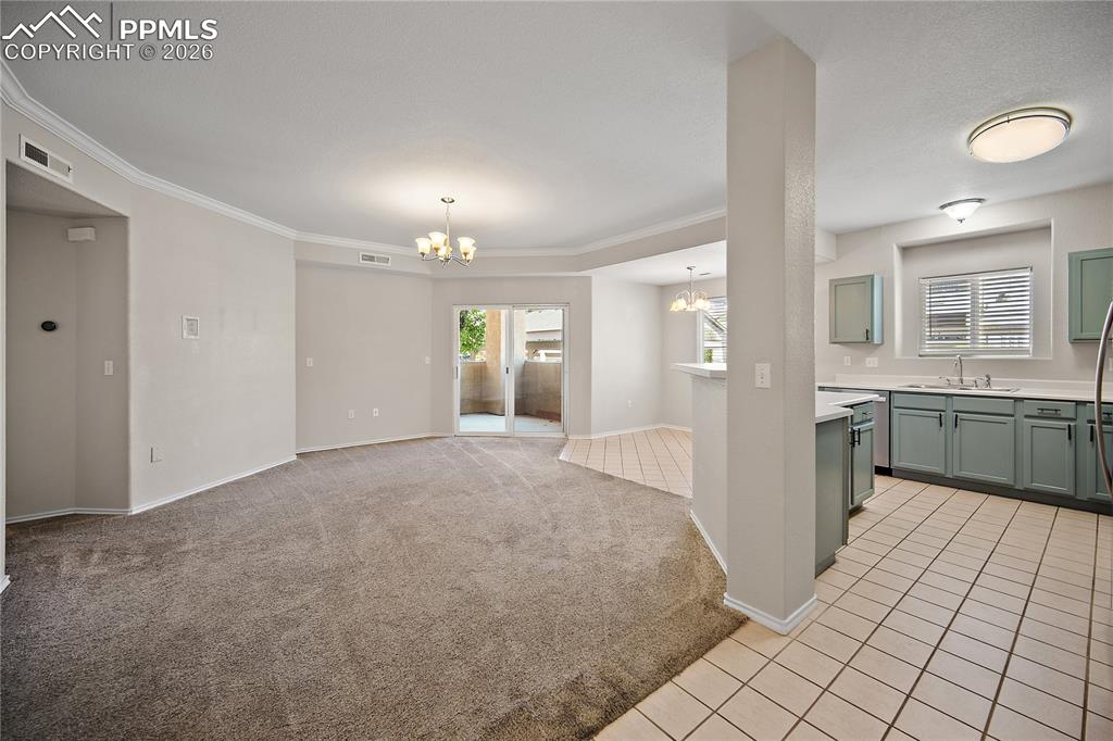 Image 6 of 31: Open-concept living space featuring plush carpeting, a sliding glass door t