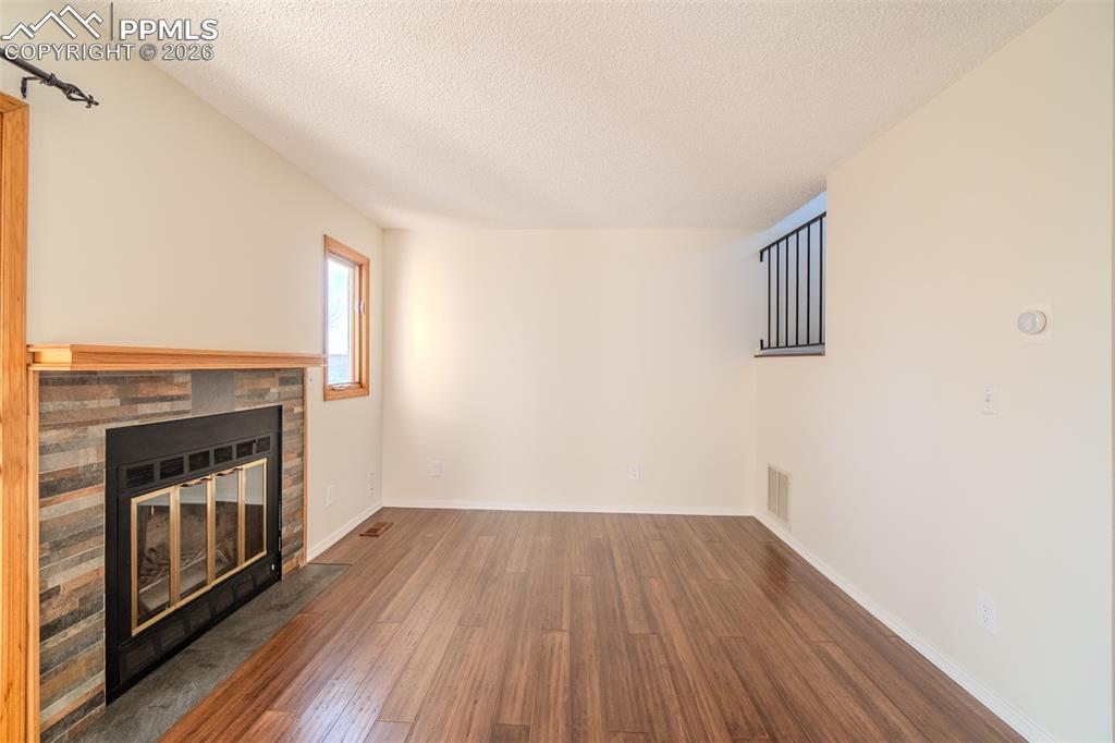 Image 11 of 26:  livingroom featuring dark wood finished floors, a fireplace with flush hea