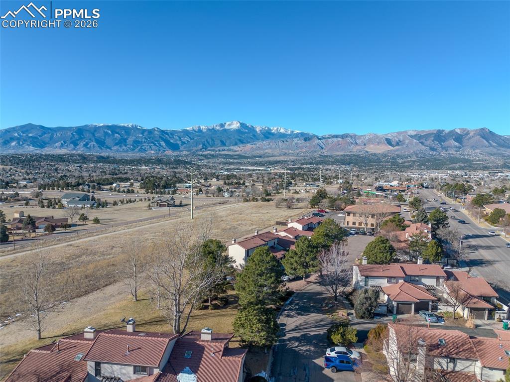 Image 25 of 26: Aerial perspective of suburban area featuring mountains