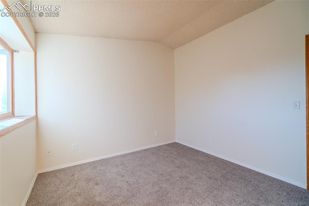 Image 4 of 26: Carpeted empty room featuring baseboards