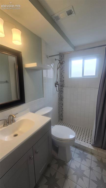 Image 10 of 43: Vanity with an integrated sink and brushed nickel faucet, patterned floor t