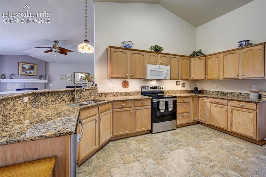 Image 11 of 50: Oak Cabinetry in the kitchen.