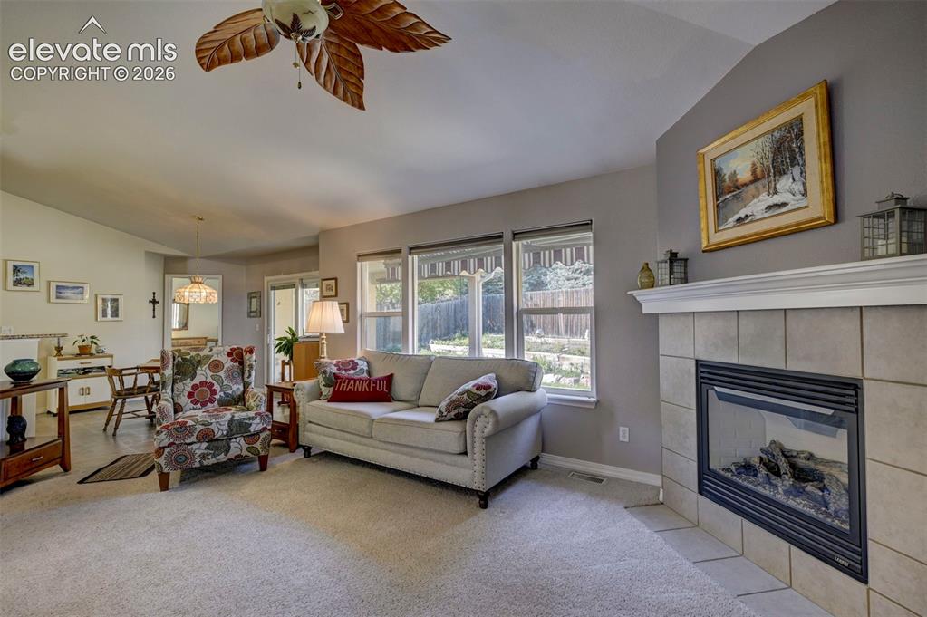 Image 20 of 50: Living room featuring large windows for natural light, a fireplace and loft