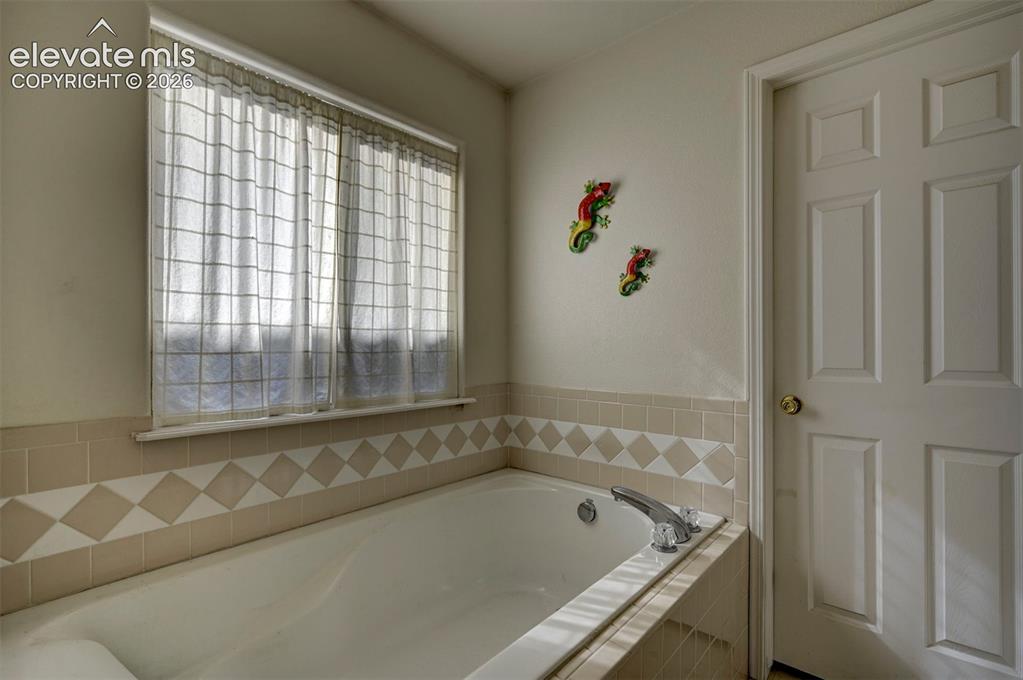 Image 28 of 50: Soaking tub in Primary Bathroom.