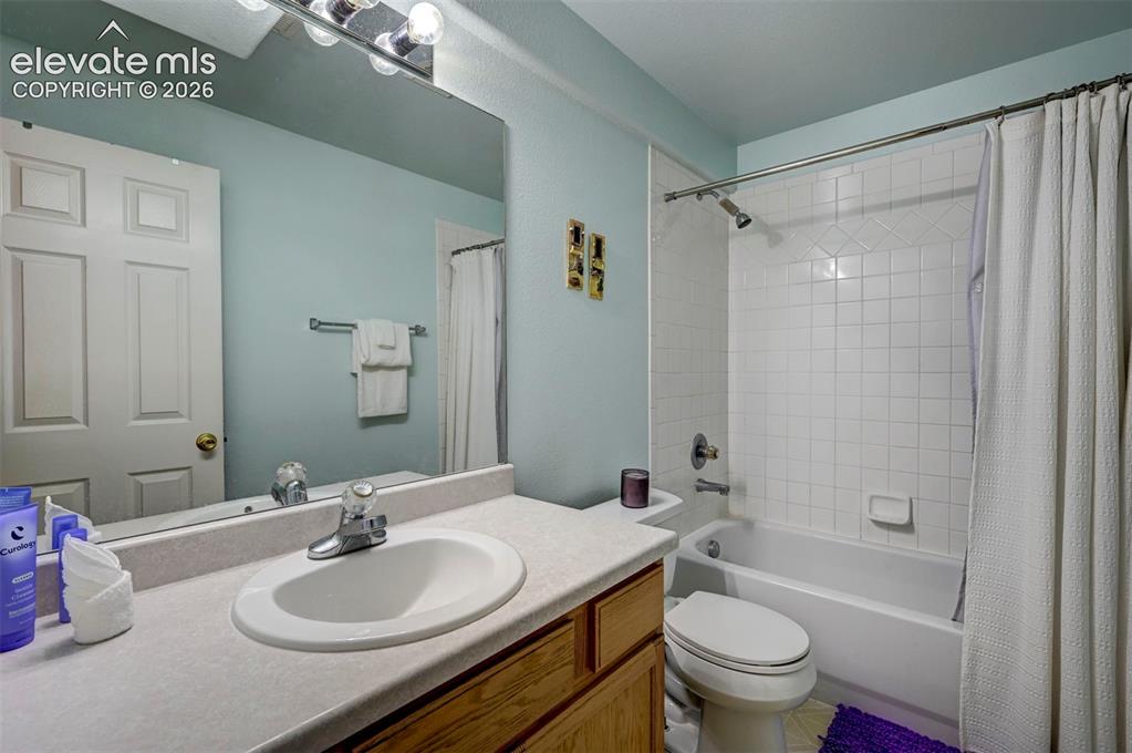 Image 38 of 50: Full bathroom in basement featuring vanity and shower / bathtub combination