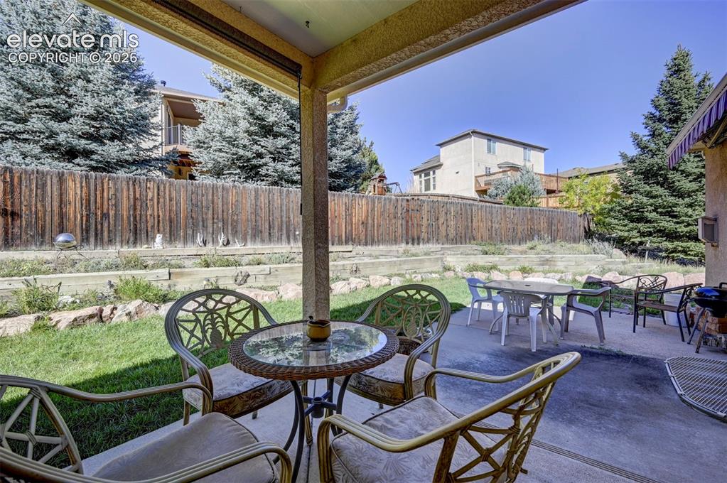 Image 41 of 50: Covered Patio overlooking the backyard.