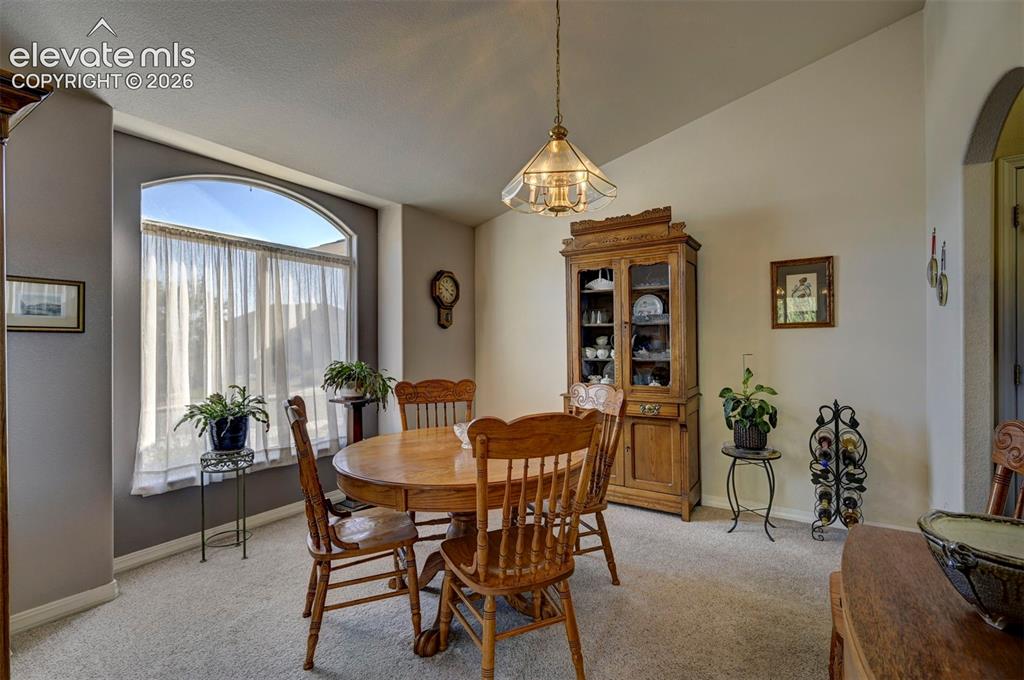 Image 6 of 50: Formal Dining Room with Picture Window