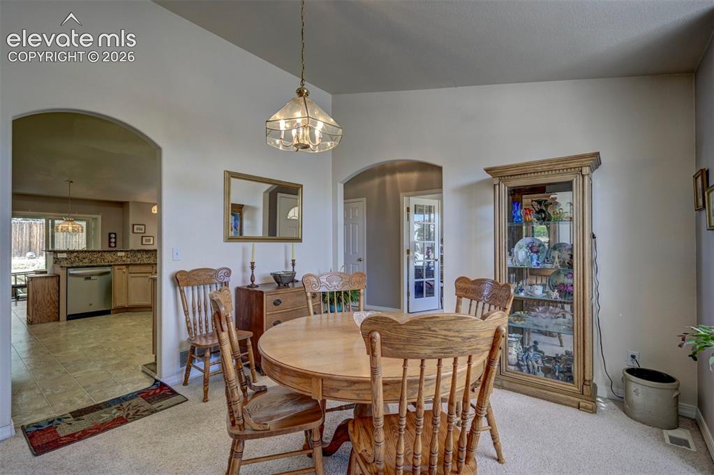 Image 8 of 50: Formal dining room leading to kitchen area.