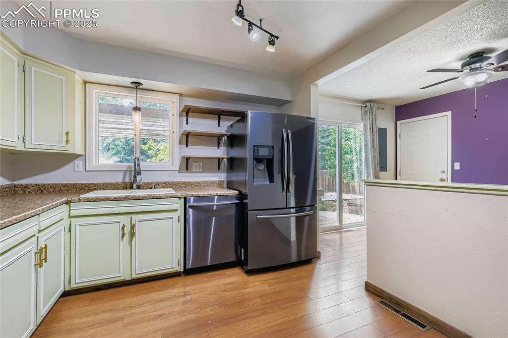 Image 10 of 28: Kitchen with stainless steel appliances, light wood finished floors, a ceil