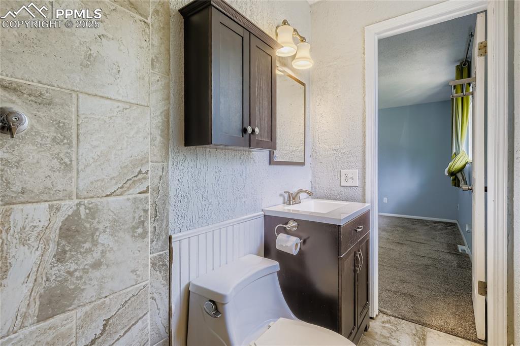 Image 13 of 28: Bathroom featuring vanity and a textured wall