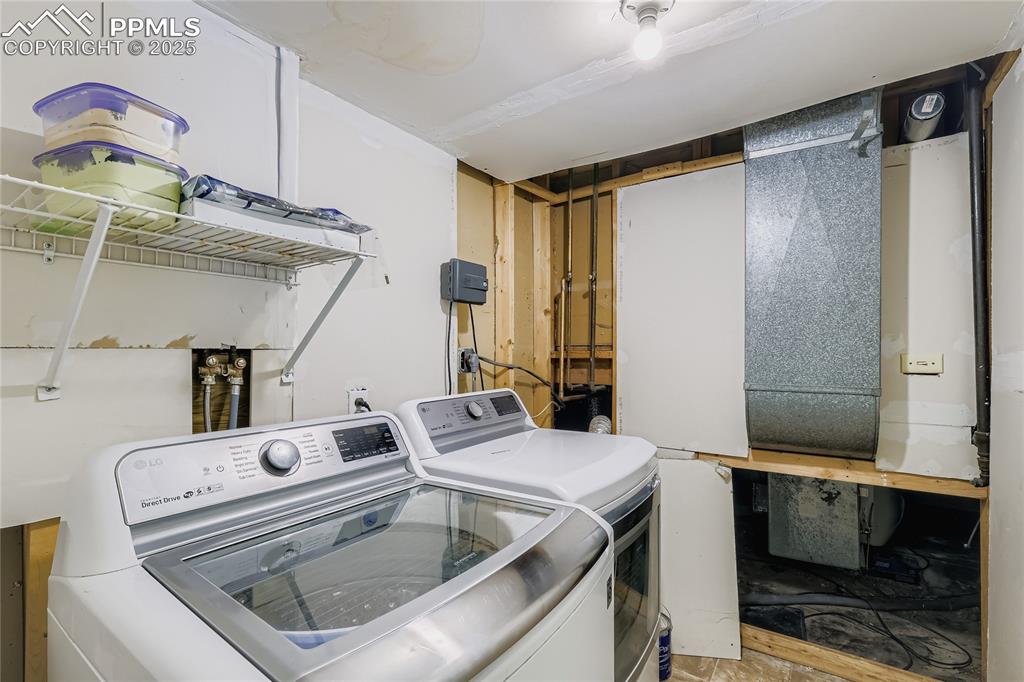 Image 24 of 28: Laundry area with washing machine and dryer