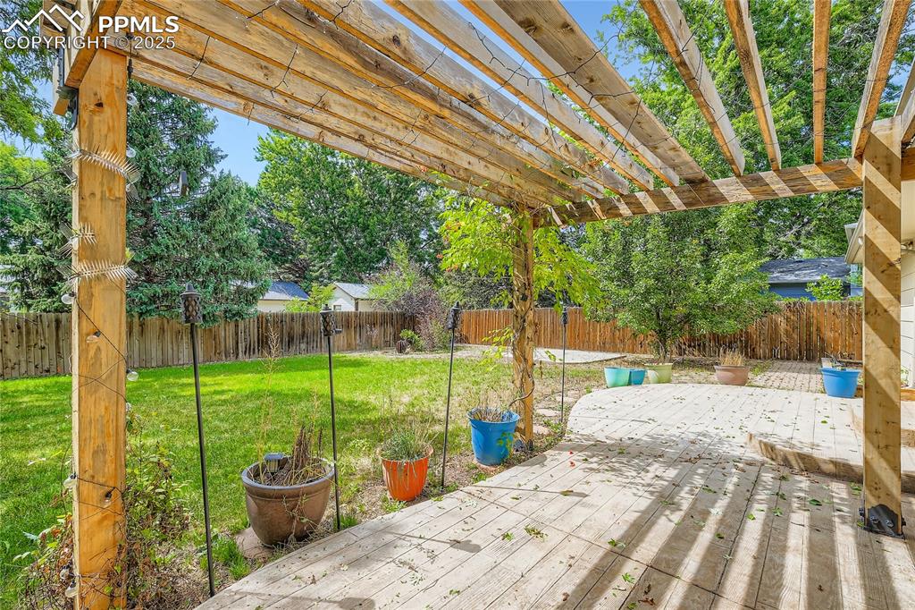 Image 26 of 28: Fenced backyard featuring a deck
