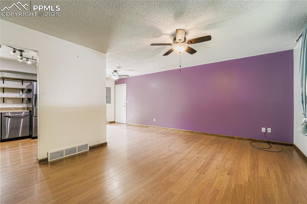 Image 4 of 28: Empty room with light wood-style flooring, a textured ceiling, and ceiling 