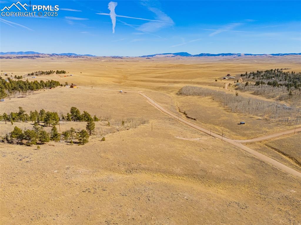 Image 5 of 11: Aerial view of sparsely populated area with a mountain backdrop