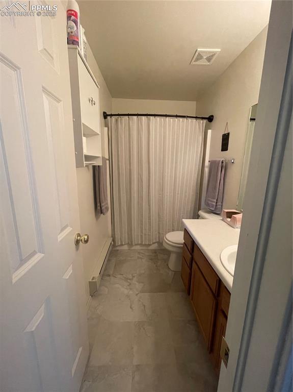 Image 11 of 24: Bathroom featuring toilet, a shower with shower curtain, vanity, and a base