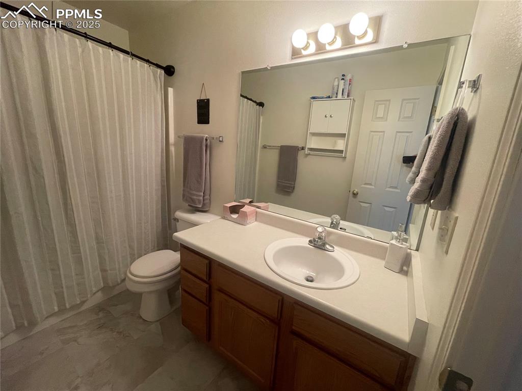 Image 12 of 24: Bathroom with toilet and vanity