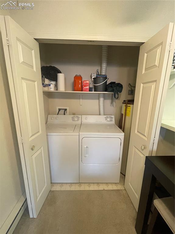 Image 7 of 24: Washroom featuring water heater, light carpet, and independent washer and d