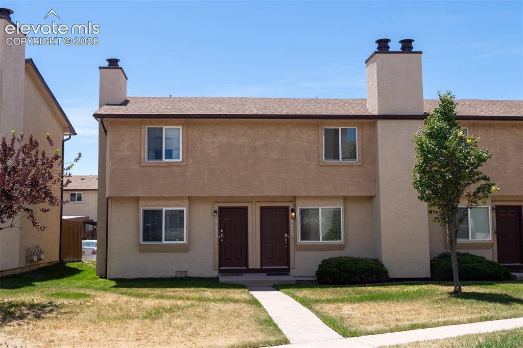 Image 1 of 31: Stucco exterior with brown trim, featuring dual entry doors, multiple windo