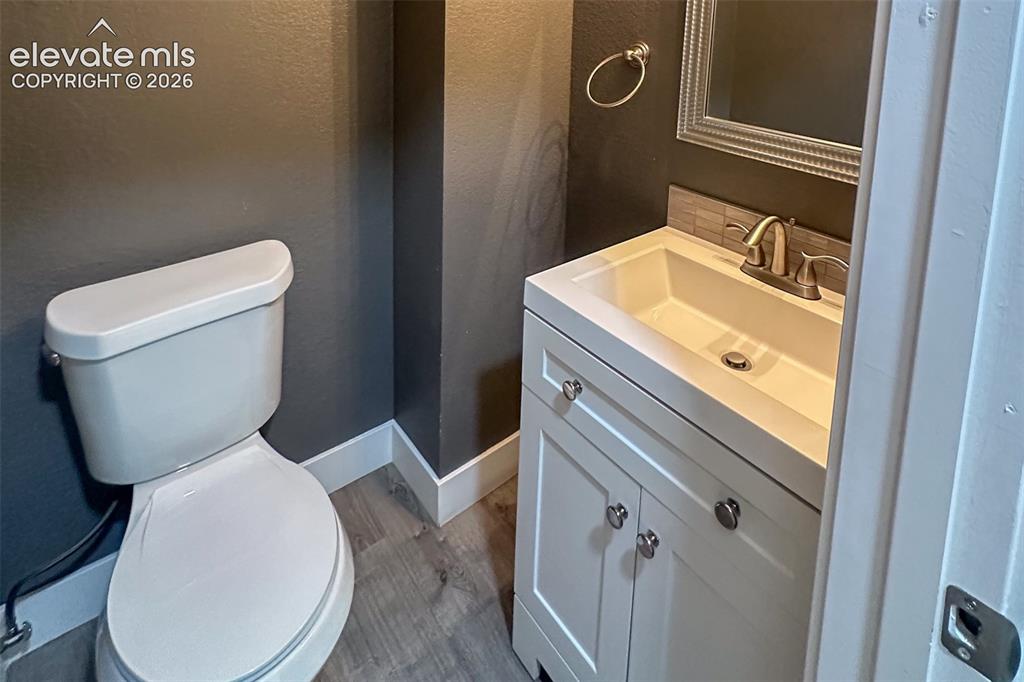 Image 14 of 31: Bathroom featuring a white vanity with integrated sink, brushed nickel fauc