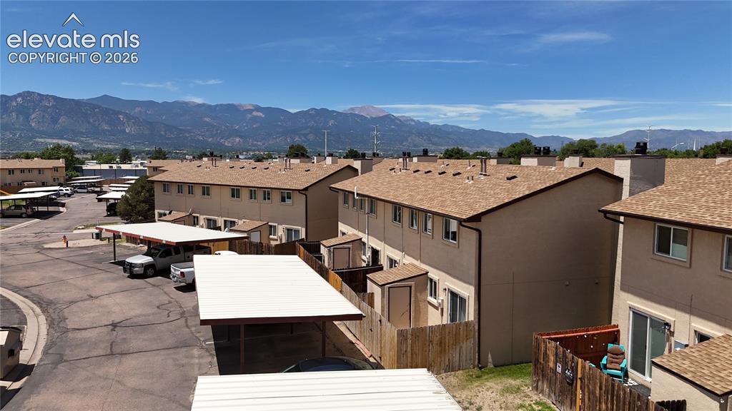 Image 31 of 31: Multi-family residential complex featuring carports and individual storage