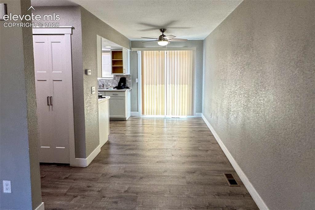 Image 6 of 31: Open concept living area featuring wood-finish flooring, textured walls, an