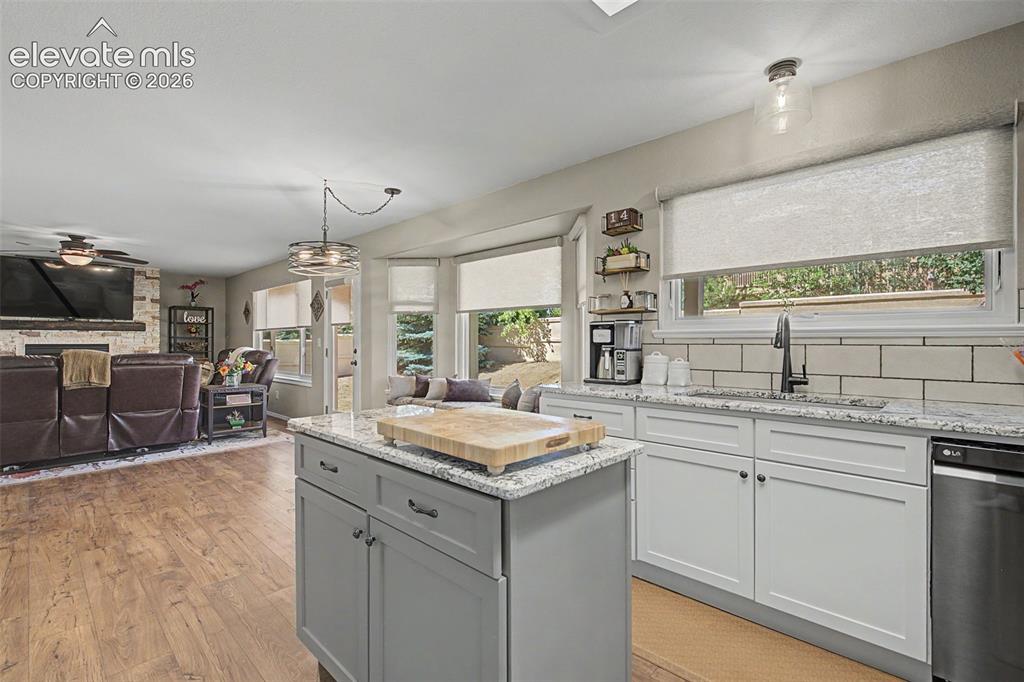 Image 10 of 37: Center island open to dining and living room