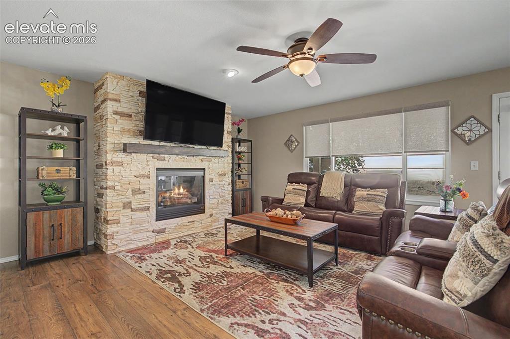 Image 12 of 37: GenStone covered gas fireplace, Mount-It! tv mount, roller shades