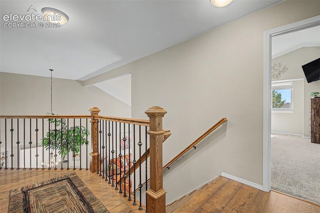 Image 18 of 37: Upstairs overlooks expansive downstairs dining and living rooms
