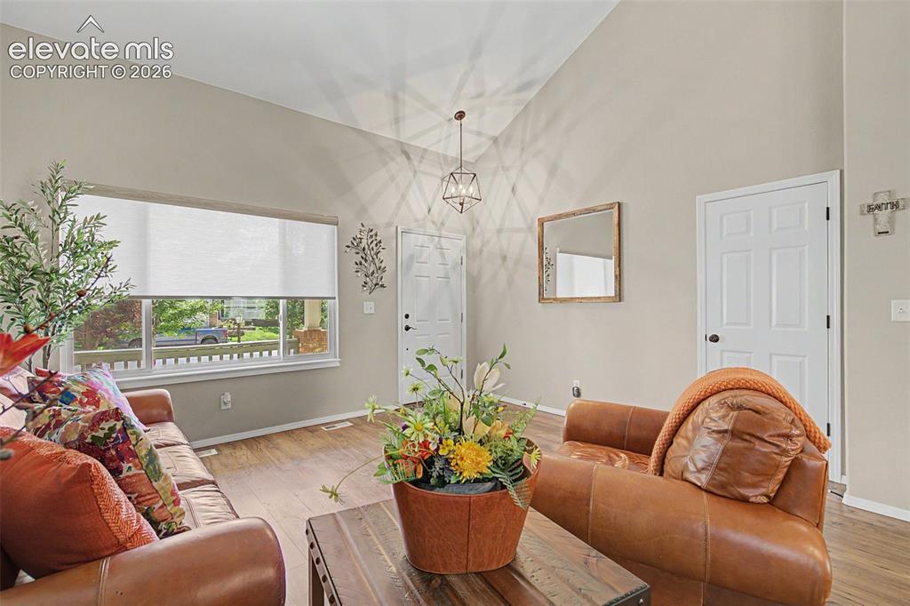 Image 5 of 37: Living room large window with Pikes Peak views