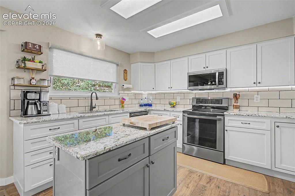 Image 8 of 37: Granite countertops, single-bowl sink, awning window