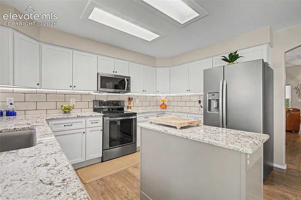 Image 9 of 37: Kitchen offers plenty of work space and under-cabinet lighting
