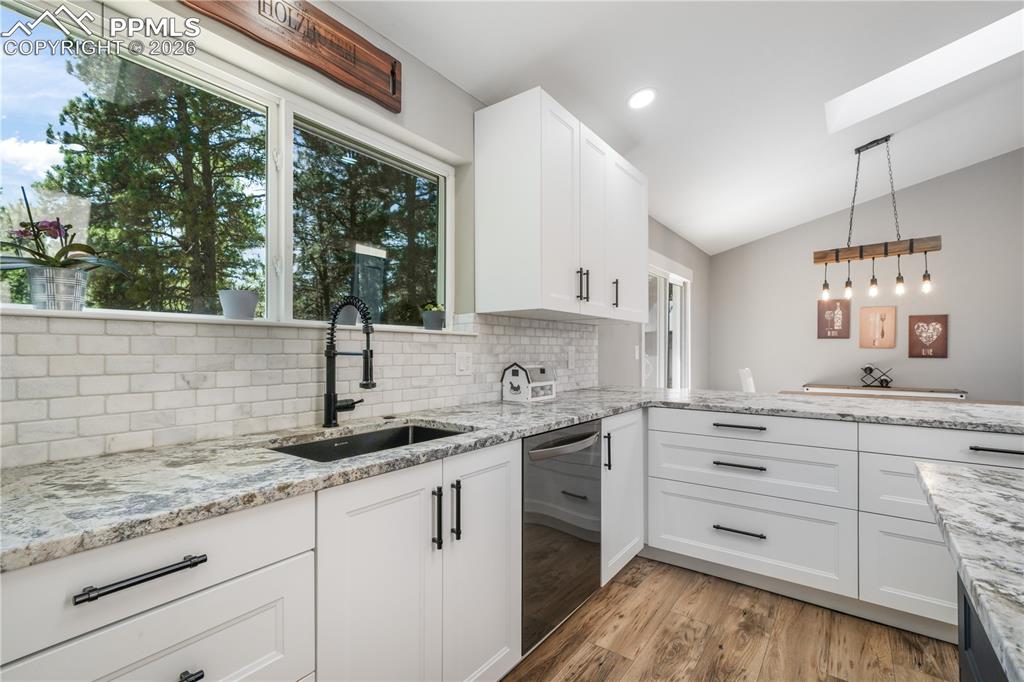 Image 14 of 50: Remodeled kitchen, granite counters, updated appliances to include inductio