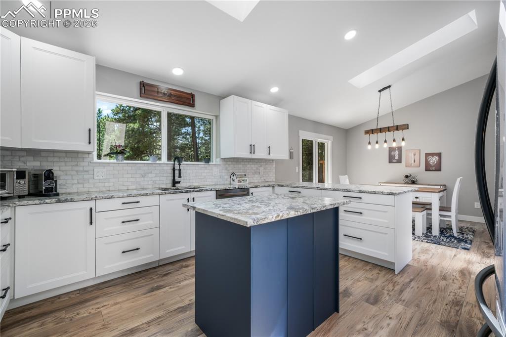 Image 15 of 50: Remodeled kitchen, granite counters, updated appliances to include inductio