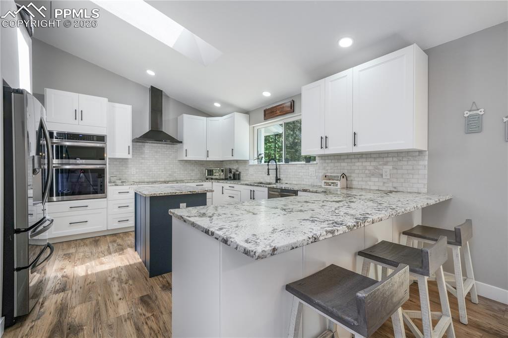 Image 17 of 50: Remodeled kitchen, granite counters, updated appliances to include inductio